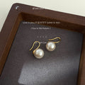 Gold Tone Hook Earrings With White Pearl Drops In Three Sizes view 7