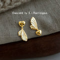 Gold-Tone Asymmetric Heart White Enamel Wing Earrings view 1
