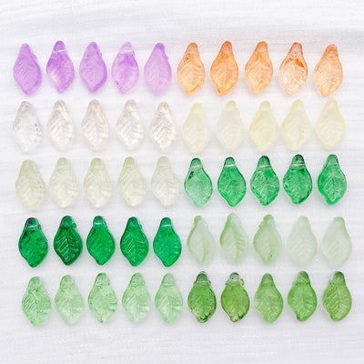 Green leaf and bead beads arranged on a light background
