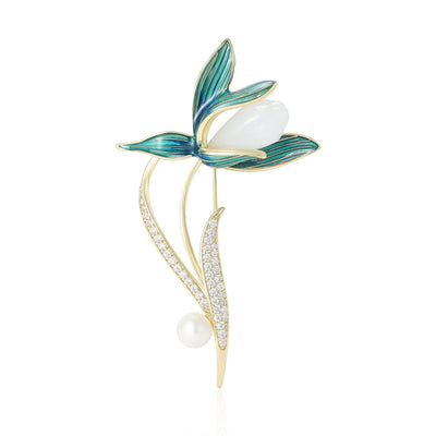 Front view showing the gold tone magnolia branch brooch with blue enamel petals