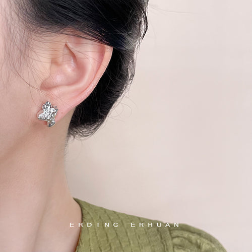 Silver abstract liquid stud worn on ear side profile