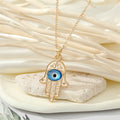 Gold Tone Blue Evil Eye and Hamsa Hand Pendant Necklaces view 7