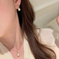 Gold Tone Pearl Drop Earrings with Textured Oval Frames view 2