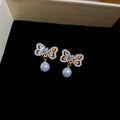 Crystal Bow Pearl Drop Stud Earrings In Gold And Silver view 6