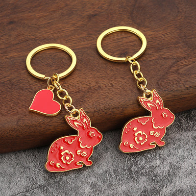Two red rabbit keychain styles with gold-tone hardware