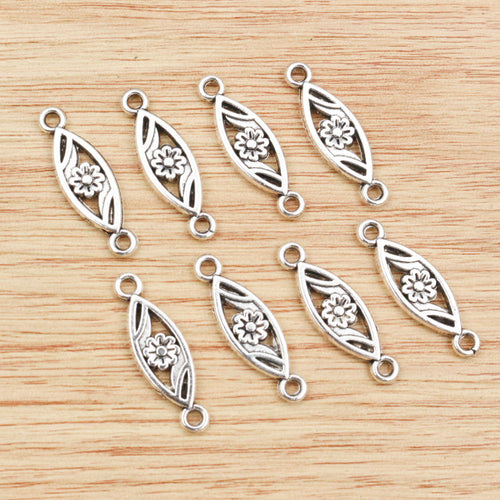 Finish comparison of slim openwork flower connector charms in two antique finishes