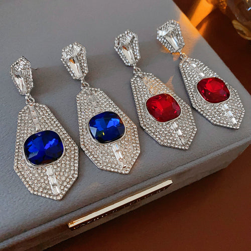 geometric crystal drop earrings displayed in a styled close view