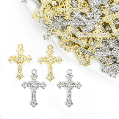 Assorted cross charms arranged on a white surface