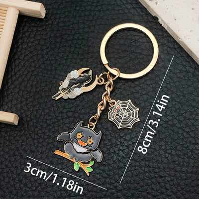 Front product photo of black owl spider web and branch halloween enamel charm keychain showing the pictured design arran