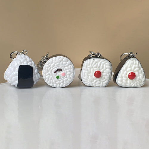 Close-up showing the colors and surface details of miniature Sushi and Rice Ball Resin Clip Keychains