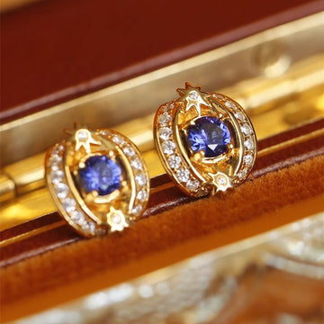 Gold Tone Blue Oval Crystal Stud Earrings with Clear Halo