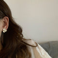 Floral Pearl Stud Earrings in White and Gold with Polished Metal Details view 2
