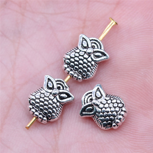 Hand held view of owl bead