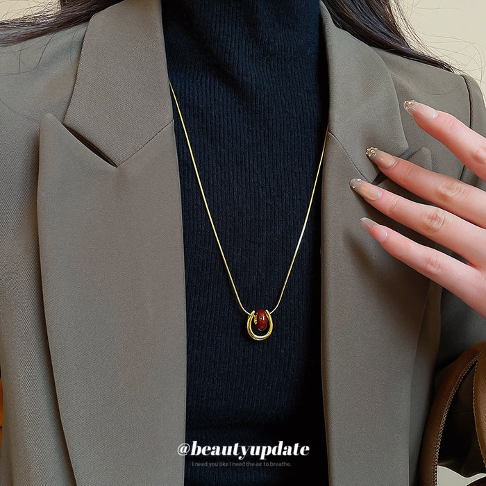 Red Teardrop Gold Tone Necklace With Polished Metal Tone Details