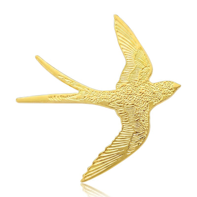 Front view of gold tone flying swallow silhouette with a finely textured surface