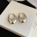 Textured and Polished Oval Hoop Earrings in Gold and Silver view 9
