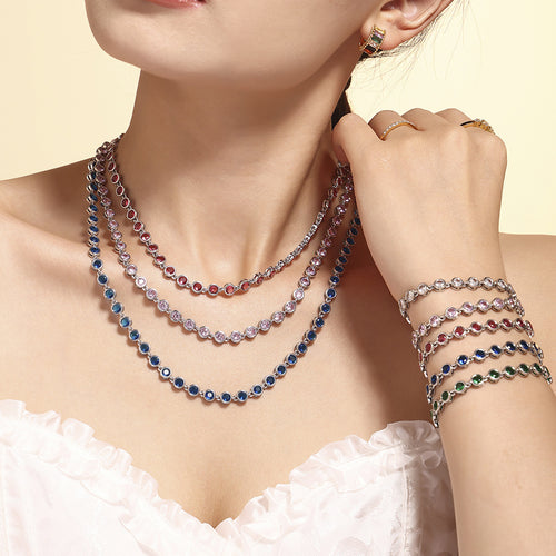 Layered steel zircon tennis necklaces and stacked bracelets on model