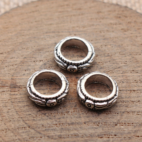 Antique Silver textured ring shaped large hole bead shown in detail view