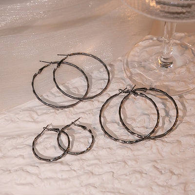 Primary supplied view of gunmetal faceted hoop earrings