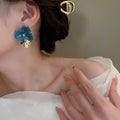 Blue Floral Statement Stud Earrings With Polished Metal Tone Details view 4