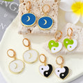 Gold Tone Crescent Disc and Yin Yang Heart Huggie Earrings view 1