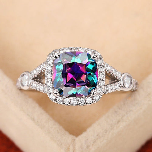 Front view of mystic multicolor halo ring on beige fabric