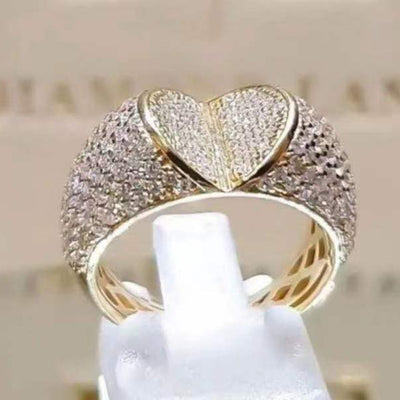 Gold full pave heart dome ring front view on white stand