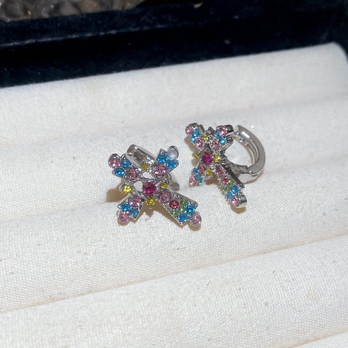 Main image 2 showing two silver-tone clip earring styles with crystal crosses in multicolor or blue, arranged detail vie