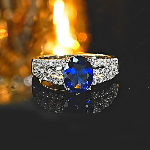 Second product view showing silver-tone deep-blue oval solitaire triple-row wide ring