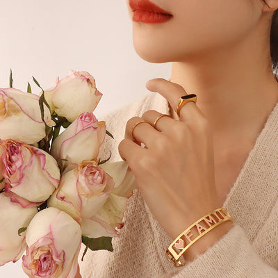 Gold FAMILY pink heart hinge bangle worn with roses and knit