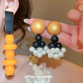Geometric Wood Bead Dangle Earrings in Two Colorways view 1