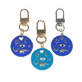 Gold Tone Round Enamel Eye and Celestial Clip Keychains view 5