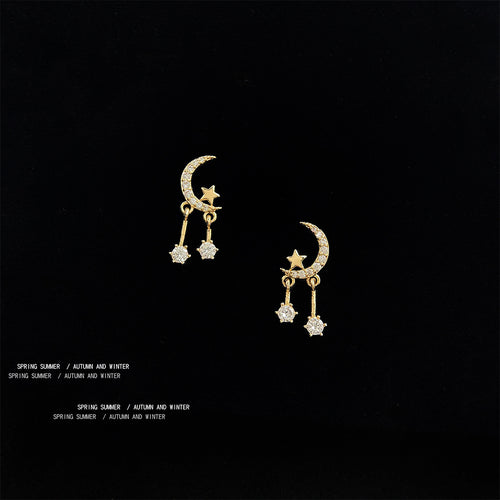 Gold-tone crescent-moon clear-star-drop studs in the first product display.