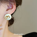 Cream Round Stud Earrings with Gold Letter M Detail view 3