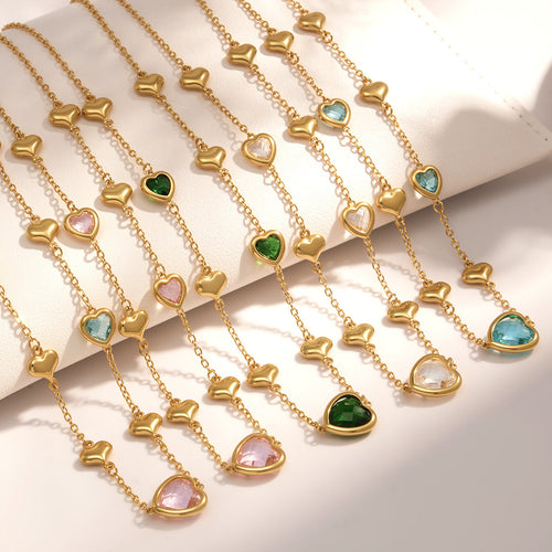 Multiple gold heart glass necklaces in assorted stone colors