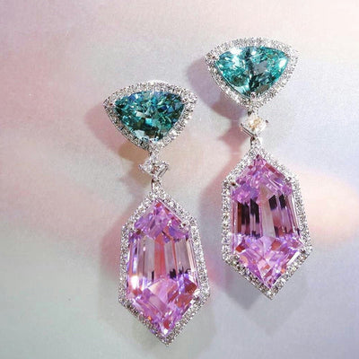 Pink and green long drop earrings on soft pastel background