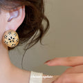 Gold Tone Oval Stud Earrings With Black Floral Cutouts view 3