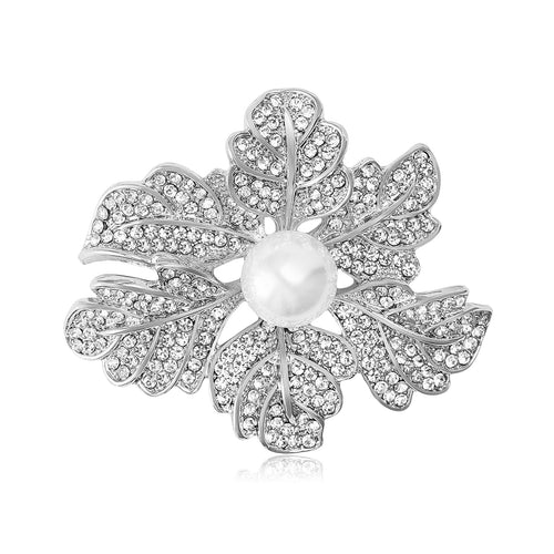 A layered crystal leaf cluster centered by a white pearl shown in a styled display.