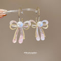 Pink Iridescent Bow Dangle Earrings With Gold Tone Hooks view 4
