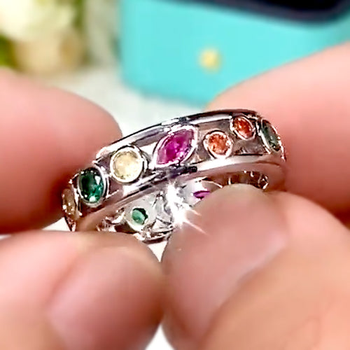 Styled view showing a row of red, green, yellow, pink, and clear round stones