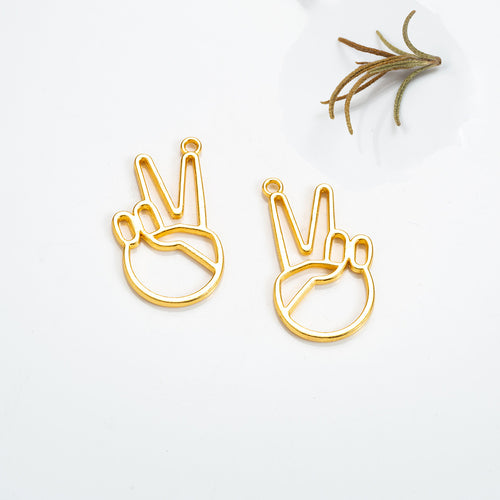 Second product image of the victory hand outline charm showing an open outline hand forming a two-finger victory sign