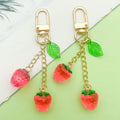 Strawberry Charm Keychains Featuring Magenta Strawberry Across 15 Pictured Variations view 1