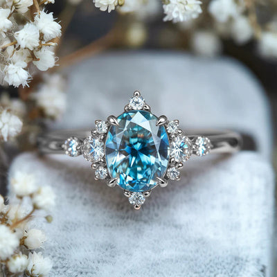 Product view showing aqua oval floral cluster three-stone ring