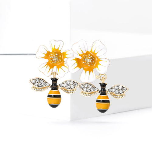 Daisy and bees brooch angled on white display block