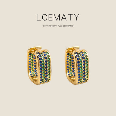 Gold blue green CZ pave square huggie hoops on beige background