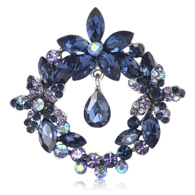 Front view of round floral crystal wreath surrounding a suspended teardrop stone