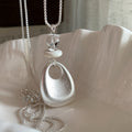 Silver Tone Sculptural Handbag Pendant Necklace with Decorative Accents view 6