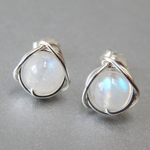 Close product view of wire wrap moonstone look studs on gray