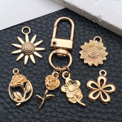 Gold-tone sunflower charms shown in a close-up product view