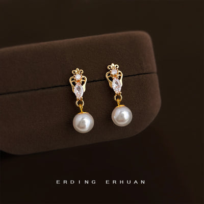 Gold crown marquise pearl drops on brown velvet jewelry case
